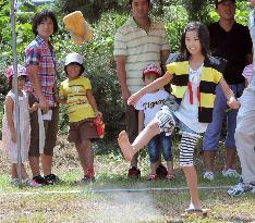 Girl competes in "geta" sandal toss competition
