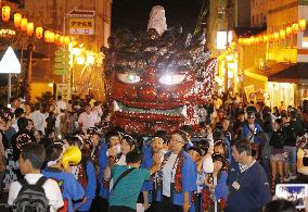 Kids carry devil palanquin at spa resort festival