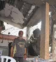 Man stands in destroyed home in Gaza