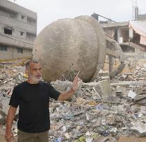 Man stands around destroyed building in Gaza