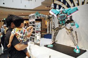 Visitors view E5 Shinkansen transformer robot