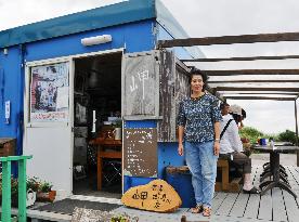 Woman stands by her cafe featured in award-winning movie
