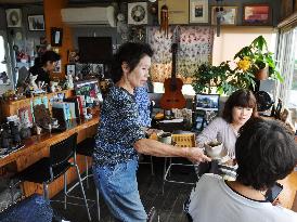 Owner of cafe set in prize-winning movie at work