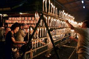 Well-wishers light candles at shrine in western Japan