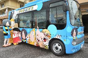 Bus with comic characters runs in author's hometown