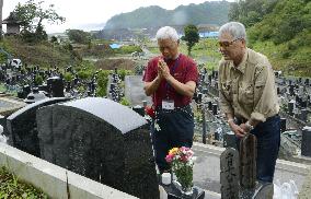 Grave visit for 2011 disaster victim