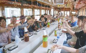 Passengers toast with sake on train in Japan
