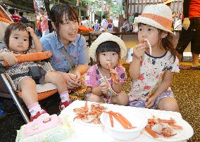Mother, children eat red snow crab meat