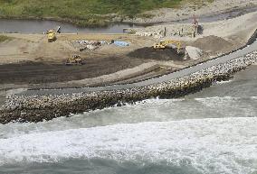 Waves lap levee being built on tsunami-hit Fukushima beach