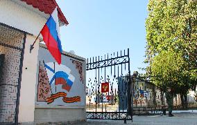 Russian flag raised at naval facility in Crimean city