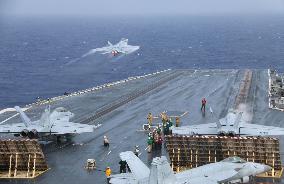 F/A-18 jet takes off from aircraft carrier in drill