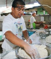 Workers make Buko pies using coconut