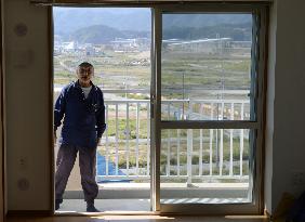 Man checks apartment built for 2011 disaster evacuees