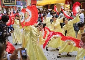 Women dance for China's National Day in Yokohama Chinatown