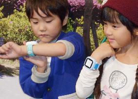 Kids demonstrate how to wear GPS watches