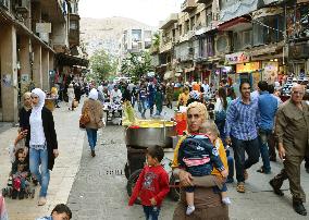 Shoppers stroll on Damascus street