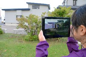 Child sees pre-quake scenery with tablet on Hokkaido isle