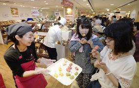 Women taste sweets at department store in Osaka