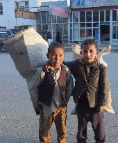 Afghan school kids collect waste paper for heating