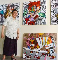 Myanmar's noted painter Win Pe shows his paintings