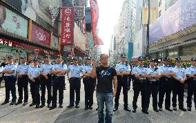 Man protests before police officers in Hong Kong