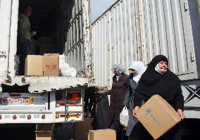 Syrian women receive relief goods amid 40% supply cut