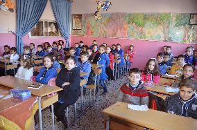 Pupils study at Syrian school after explosion
