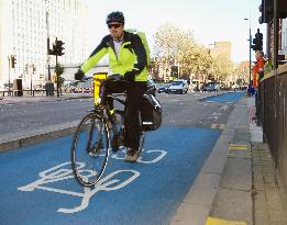 Man rides bicycle on Cycle Superhighway in London
