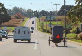 Amish horse-drawn cart runs on road in Lancaster, Penn.