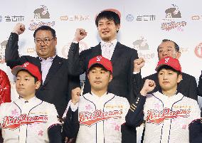 Amateur baseball team officials, players strike pose