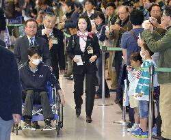 Figure skater Hanyu returns to Japan in wheelchair