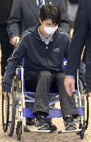 Figure skater Hanyu returns to Japan in wheelchair