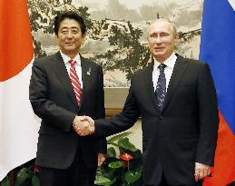 Japan's Abe, Russia's Putin meet in Beijing