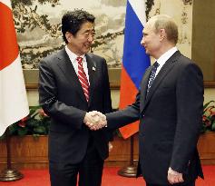 Japan's Abe, Russia's Putin meet in Beijing