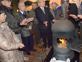 People surround replica of Japan's 1st stove