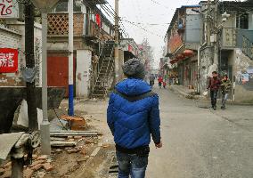 Man belonging to 'ant tribe' walks in Beijing suburb