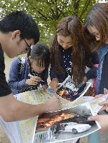 High schoolers check map in outdoor disaster education