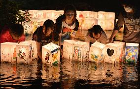 Kobe kids put paper lanterns on river cleaned by locals