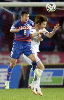 Kofu's Abe, FC Tokyo's Yoshimoto jump for header