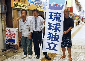 Leader of Okinawa independence drive holds banner