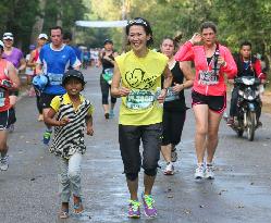 Arimori runs with kid in Angkor Wat half marathon