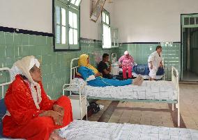Leprosy patients sit on beds in Casablanca suburb