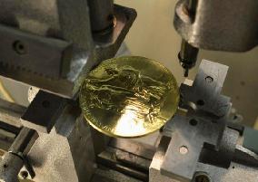 Close-up view of Nobel Prize medal being made