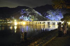 Kyoto's bridge, foothills lit up ahead of lantern festa