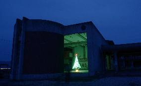 Christmas tree illuminated at tsunami-ruined school