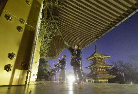 Staff members clean up Japan temple prior to new year