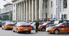 Taxis await passengers in front of Pyongyang Station
