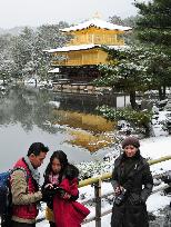 Tourists visit snow-covered Kinkaku-ji temple in Kyoto