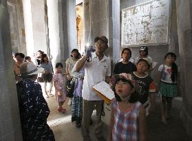 Children tour inside Peace Tower in southwestern Japan