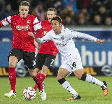 Hannover's Kiyotake in action against Freiburg player